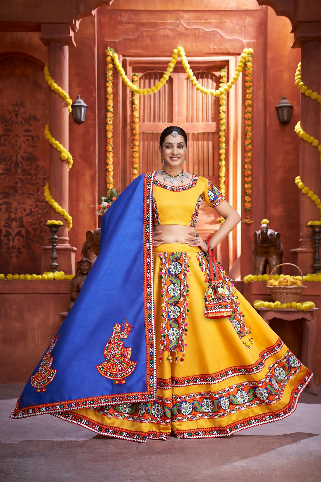 Yellow art silk lehenga choli with blue dupatta for Navratri festive wear