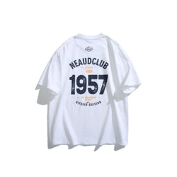 Back view of a white loose casual T-shirt featuring a large black and orange 1957 graphic print and front chest detail.
