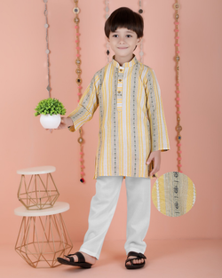 Young boy wearing a bright yellow cotton full-sleeved striped kurta with matching pyjamas