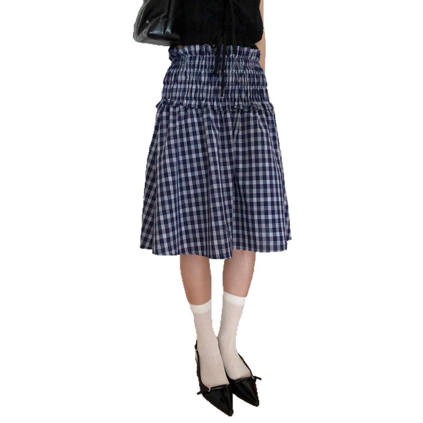 Model wearing a blue and white plaid smocked waist midi skirt with a black top and black shoes.