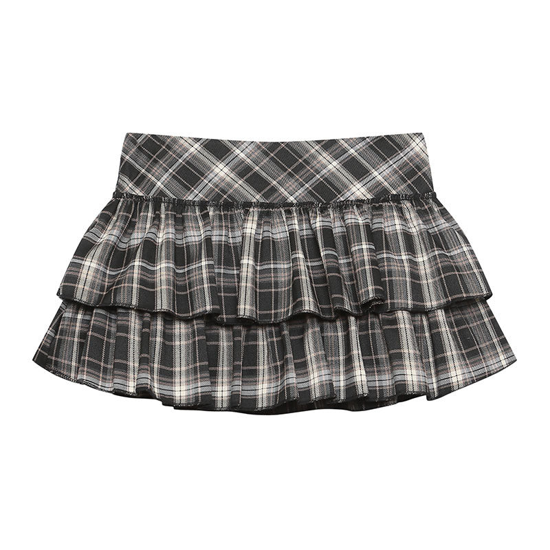 Women's black and white plaid tiered ruffle A-line mini skirt, shown on a model.
