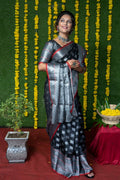 Chic black soft handloom silk saree with zari woven borders and matching blouse.