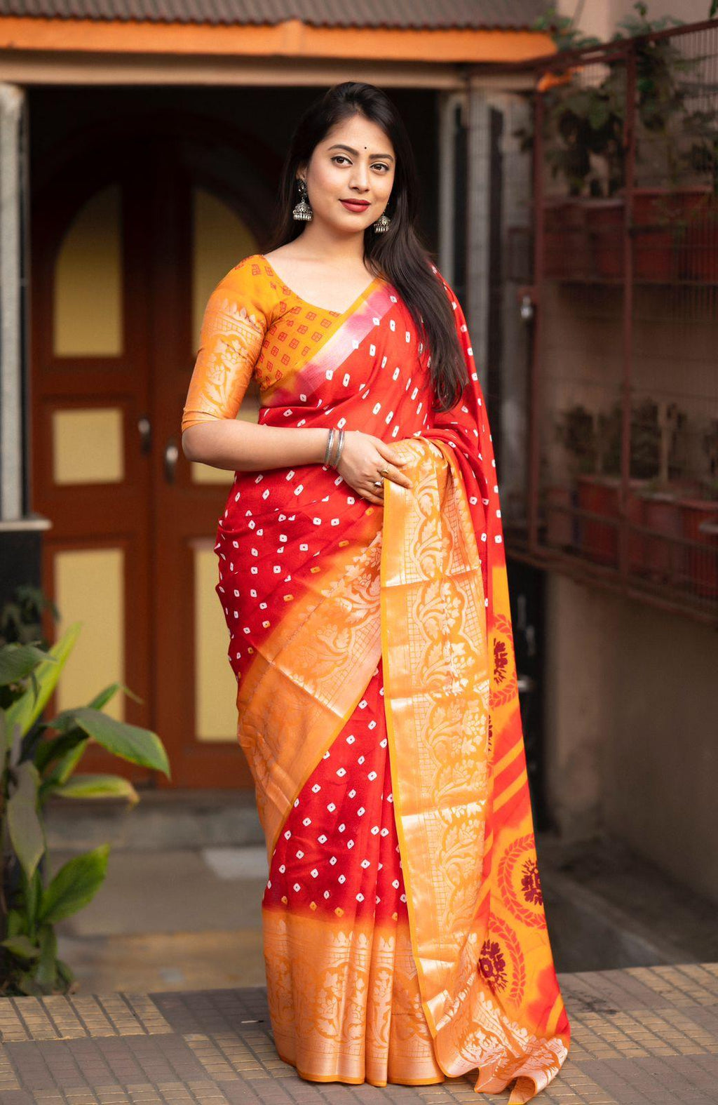 Red jute silk saree with bandhani print and cut broaso border with unstitched blouse