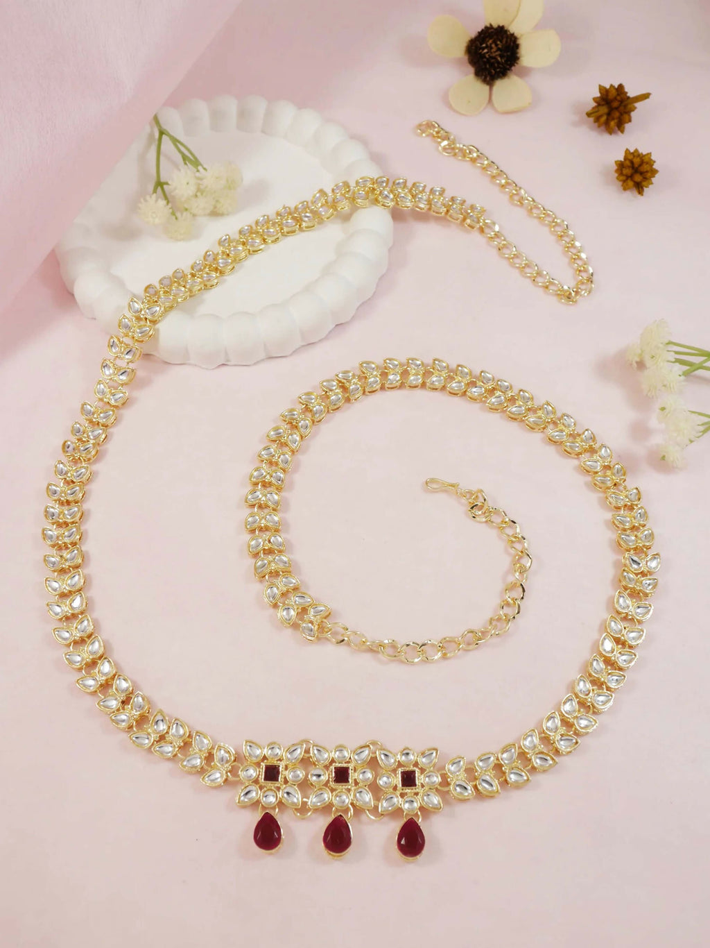 A elegant golden zinc alloy waist chain for women displayed on a clean background
