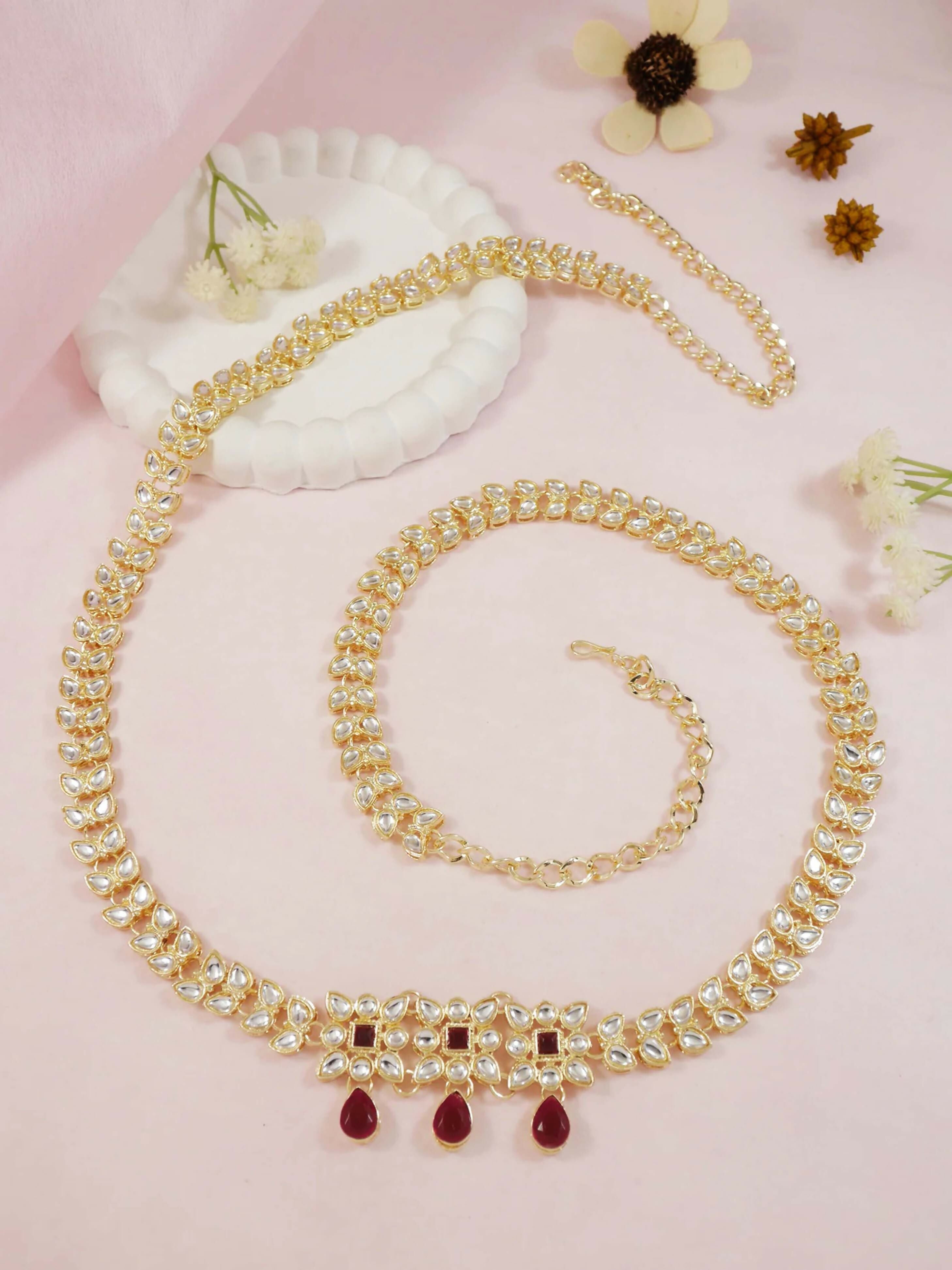 A elegant golden zinc alloy waist chain for women displayed on a clean background