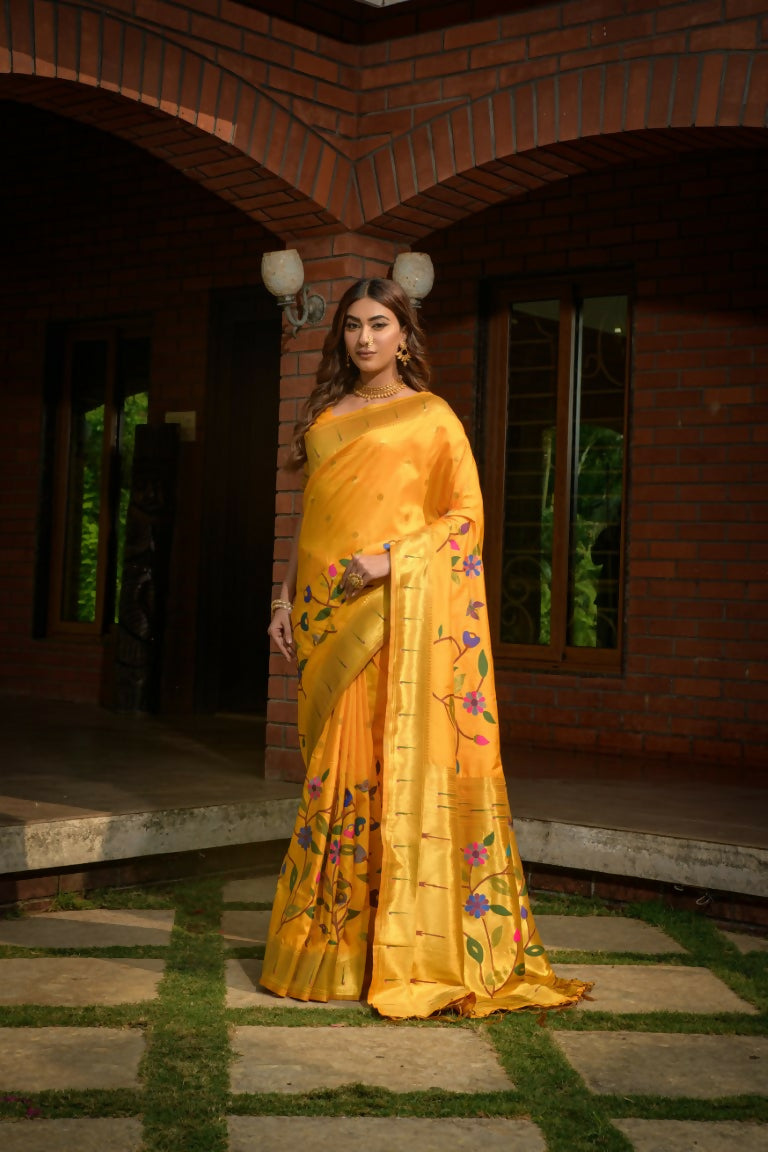 A beautiful yellow Paithani silk saree with detailed zari weaving, perfect for traditional events.