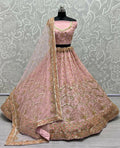 Pink bridal net lehenga choli with heavy sequins and intricate handwork.