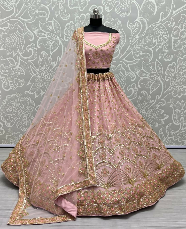 Pink bridal net lehenga choli with heavy sequins and intricate handwork.