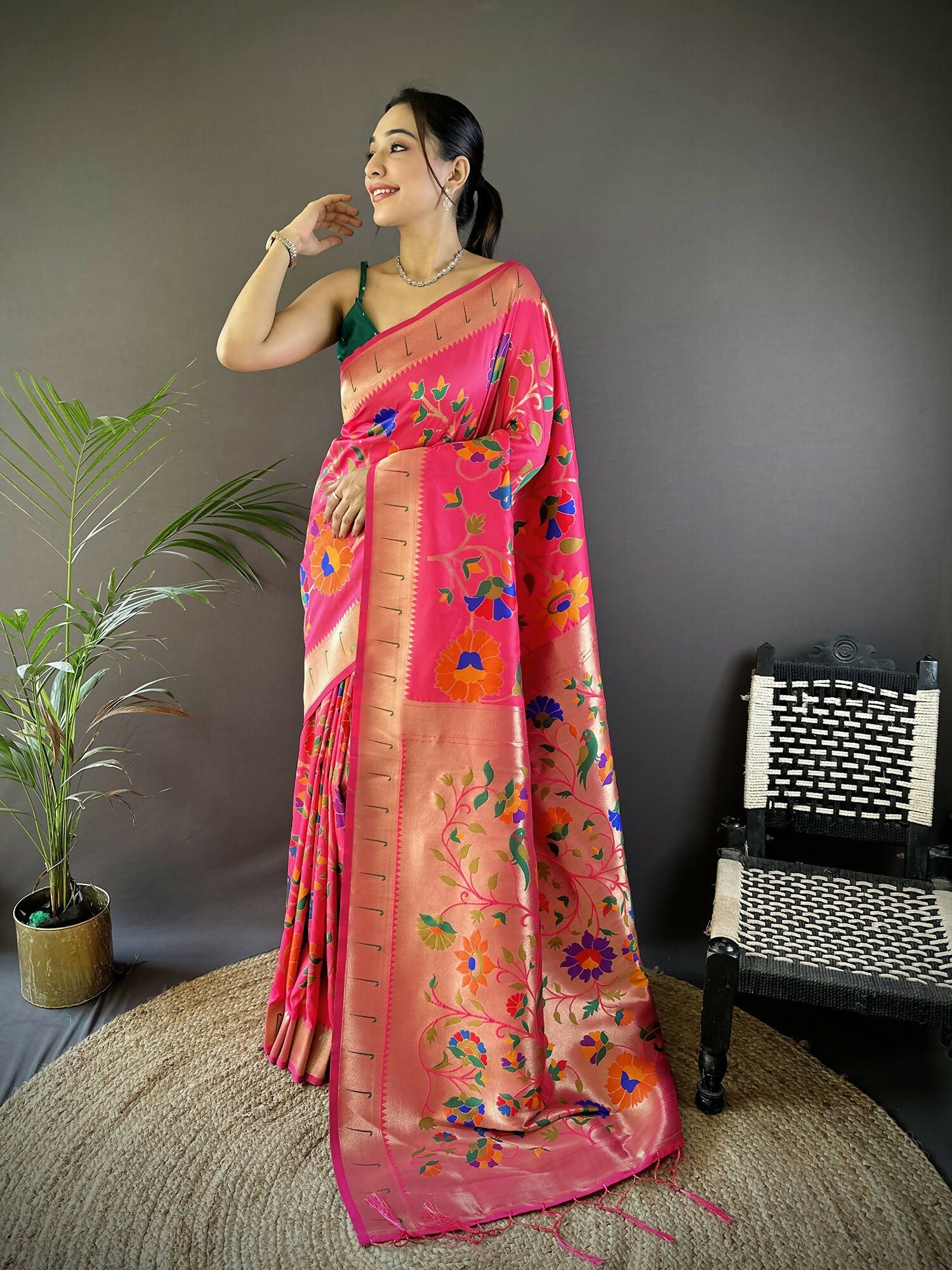 Reddish pink soft silk Paithani saree with intricate zari floral weaving.