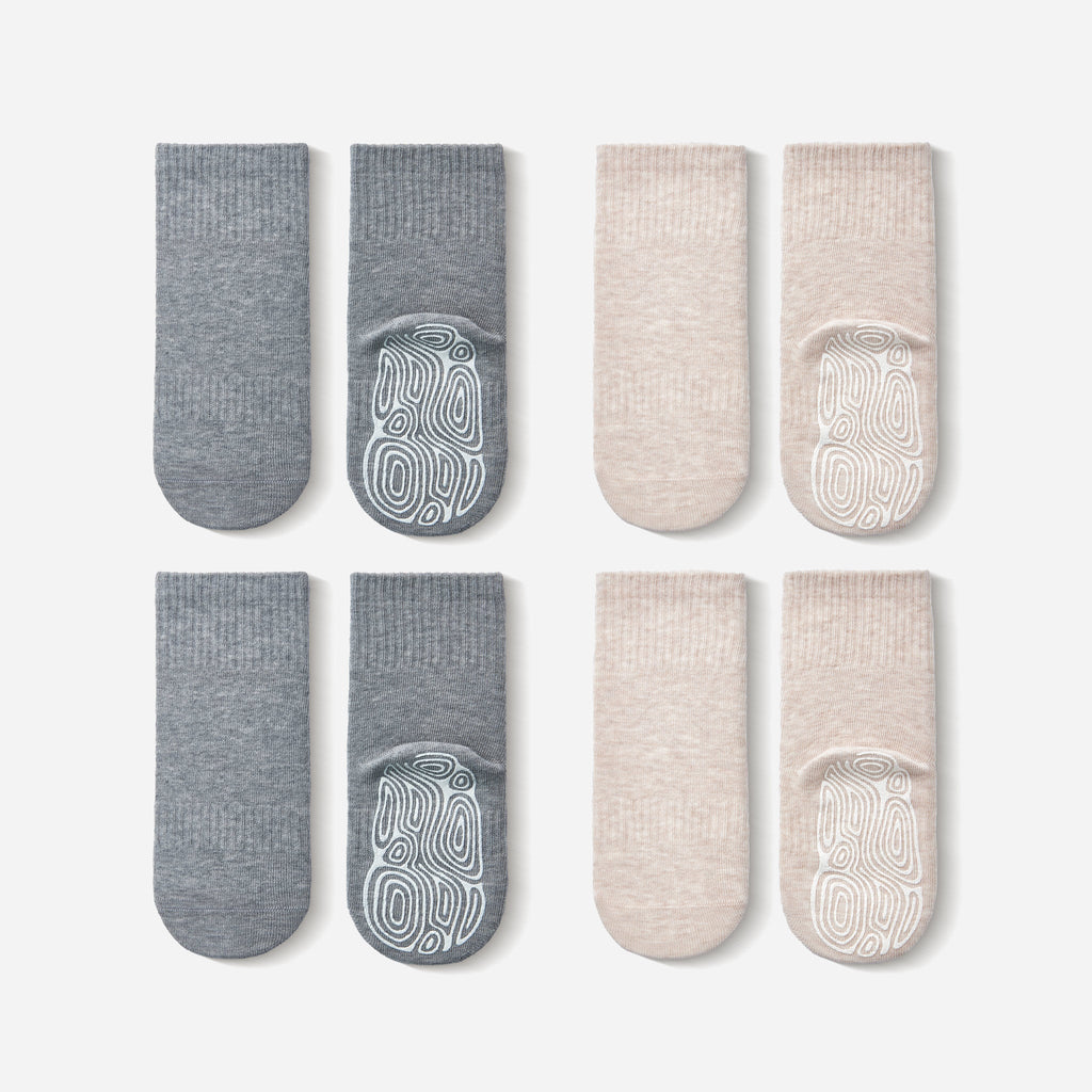 Close up of organic cotton non-slip socks for toddlers, featuring beige and grey colors with silicone grip details.