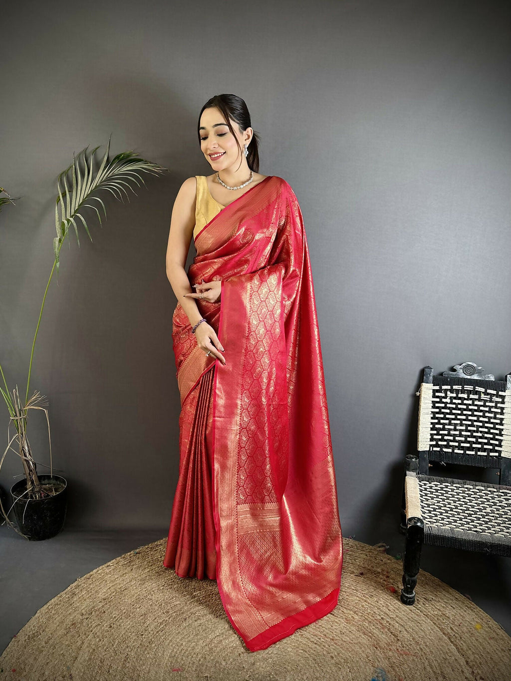 Red Banarasi soft satin silk saree featuring paisley and floral patterns with matching blouse fabric