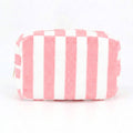 Pink striped terry cloth cosmetic pouch with zip closure and plush texture