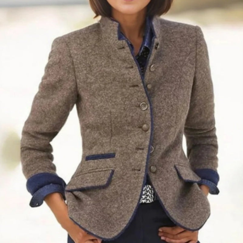 A woman wearing a tailored color-block woolen jacket with a multi-button front closure in a professional studio setting.