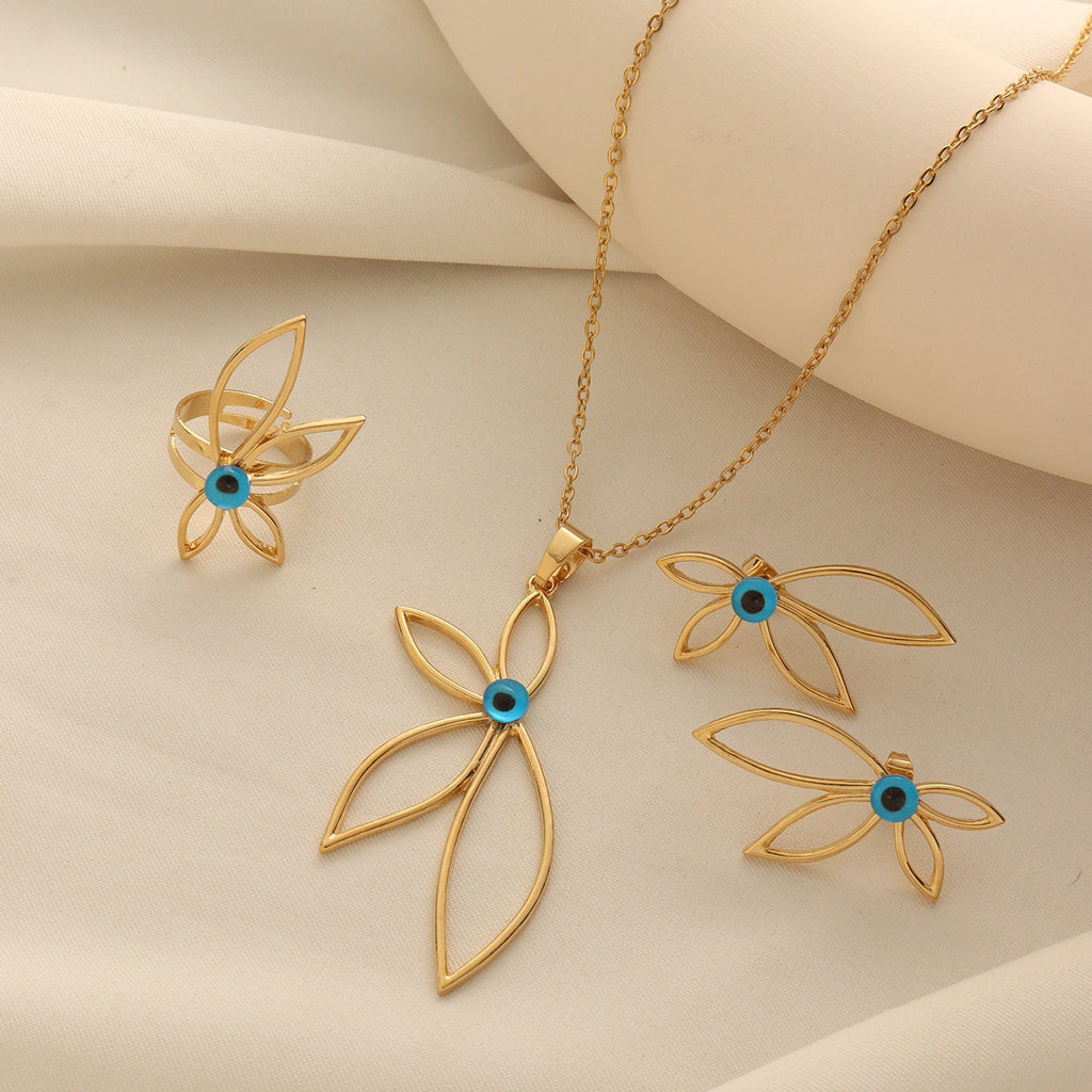 Gold-tone petal shaped jewelry set featuring blue evil eye centers, including a necklace, earrings, and a ring.