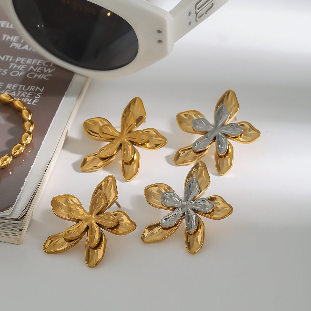 Exquisite 18K gold and silver-toned floral earrings with detailed craftsmanship