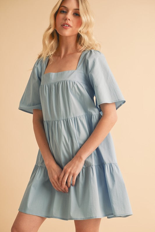 A light blue cotton tiered midi dress with square neck and half sleeves