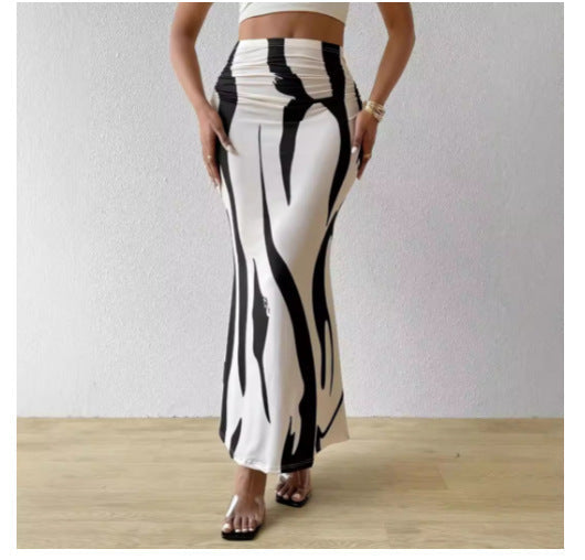 Close up of a high-waisted, fitted midi skirt with a black and white zebra animal print and fishtail hem.