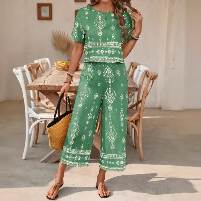 A woman wearing a two-piece set with a matching ethnic print top and cropped straight-leg pants.