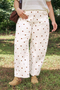 Model wearing white and brown polka dot wide-leg barrel jeans with ankle-length cut and colorblock stitching.