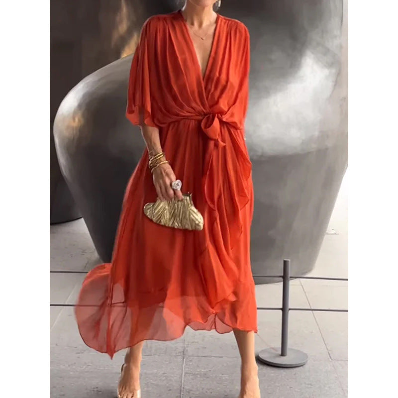 Woman wearing a loose-fit batwing sleeve V-neck fairy dress in a mid-length cut