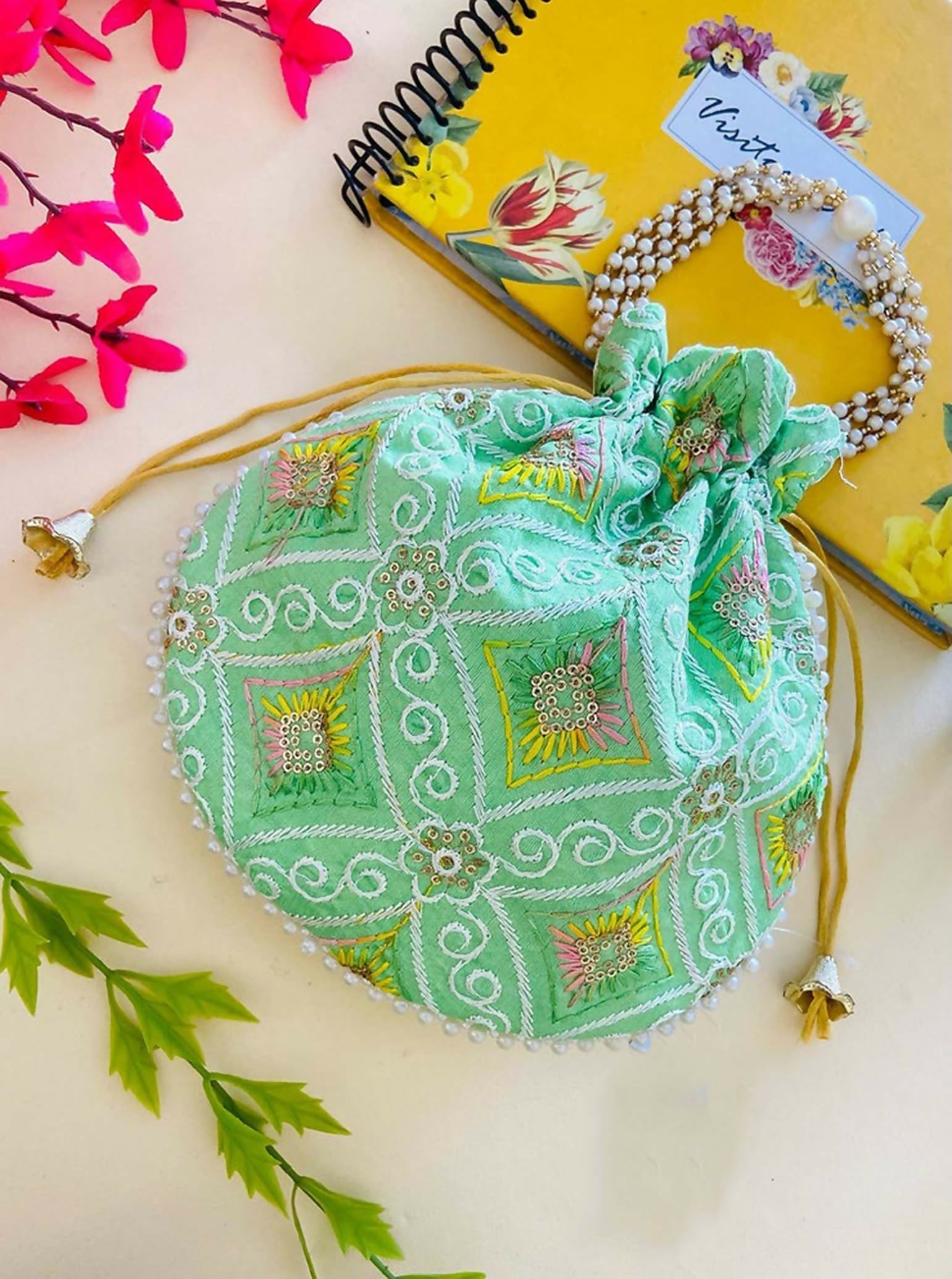 Green synthetic ethnic potli bag, perfect for festive weddings and celebrations