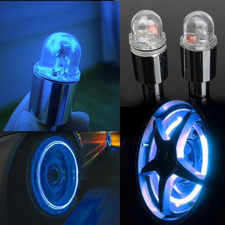 Close up of bicycle wheel tire valve cap with glowing LED safety light