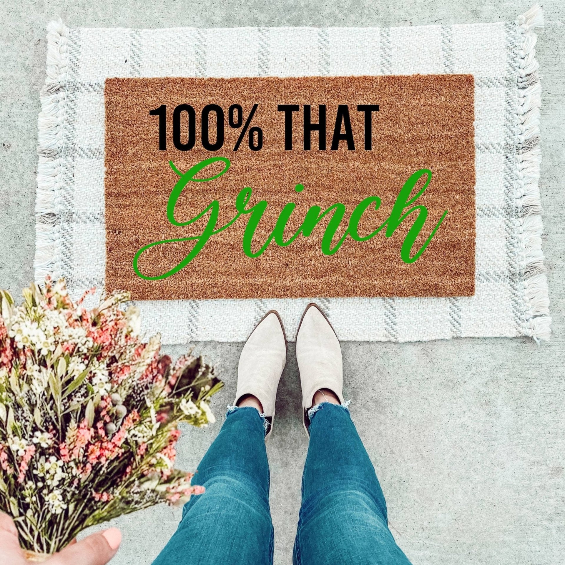 100% That Grinch themed doormat in brown, green, and black colors