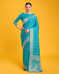 A Blushing Cyan Banarasi silk saree with silver geometric zari weaving in a traditional formal style.