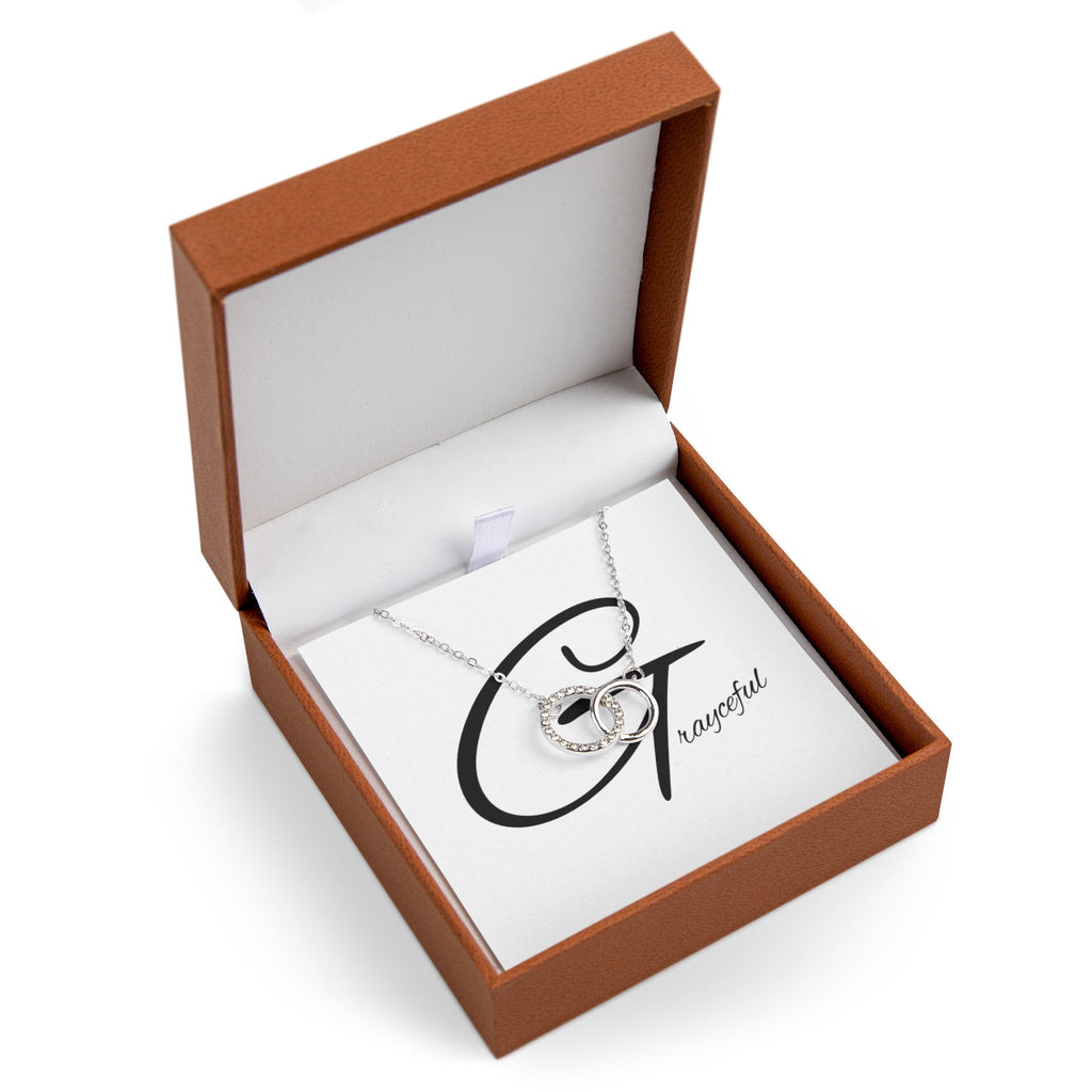 Polished silver interlocking circles necklace with pave cubic zirconia accents on a cable chain