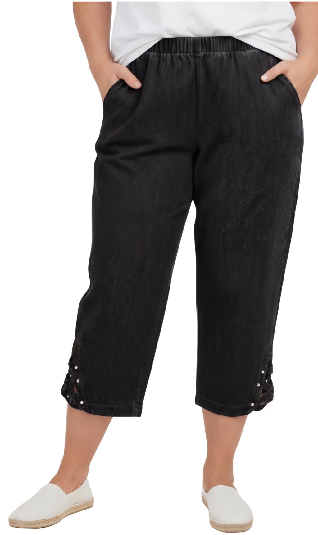 Woman wearing relaxed-fit lightweight denim capri pants with decorative studs at the hem