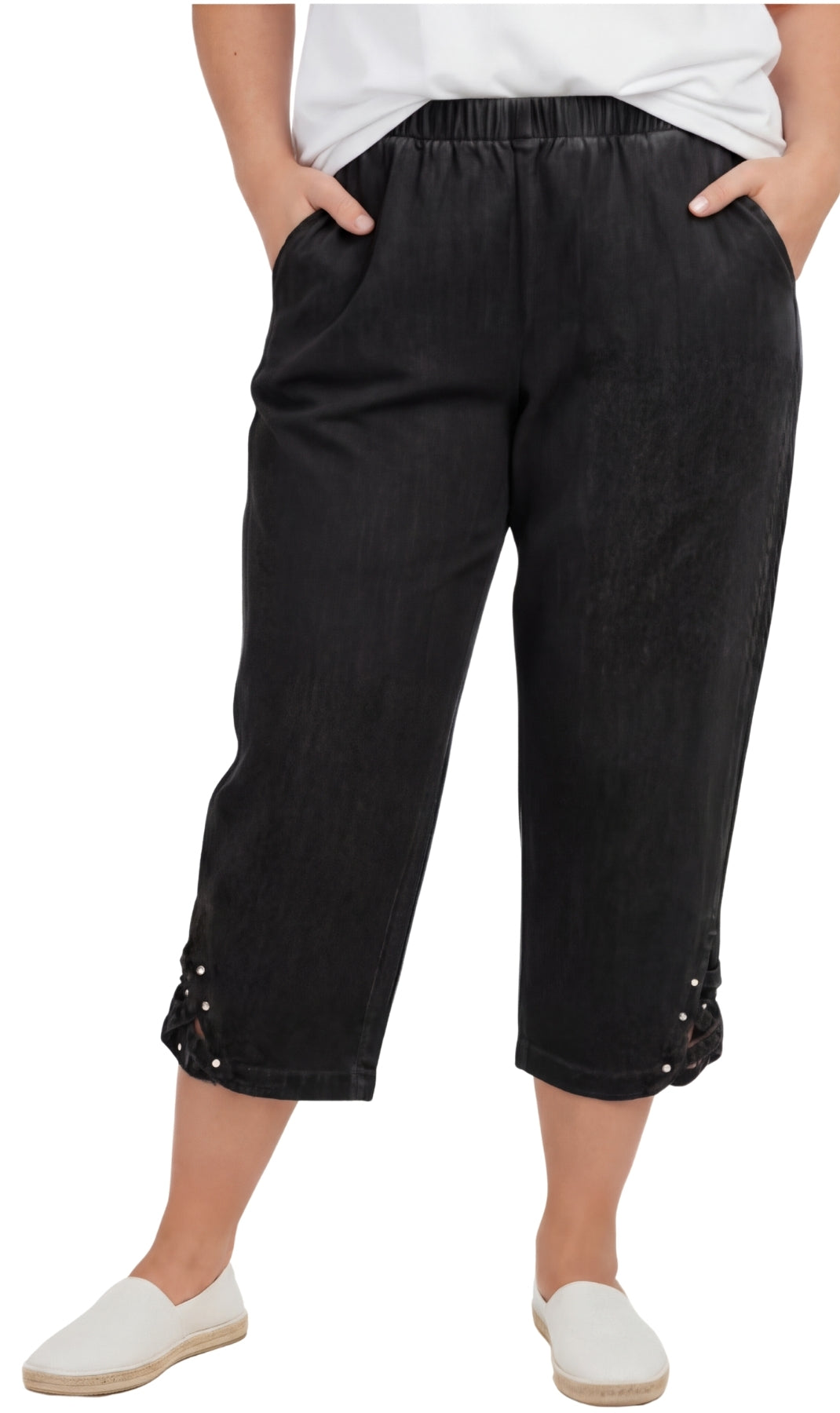 Woman wearing relaxed-fit lightweight denim capri pants with decorative studs at the hem