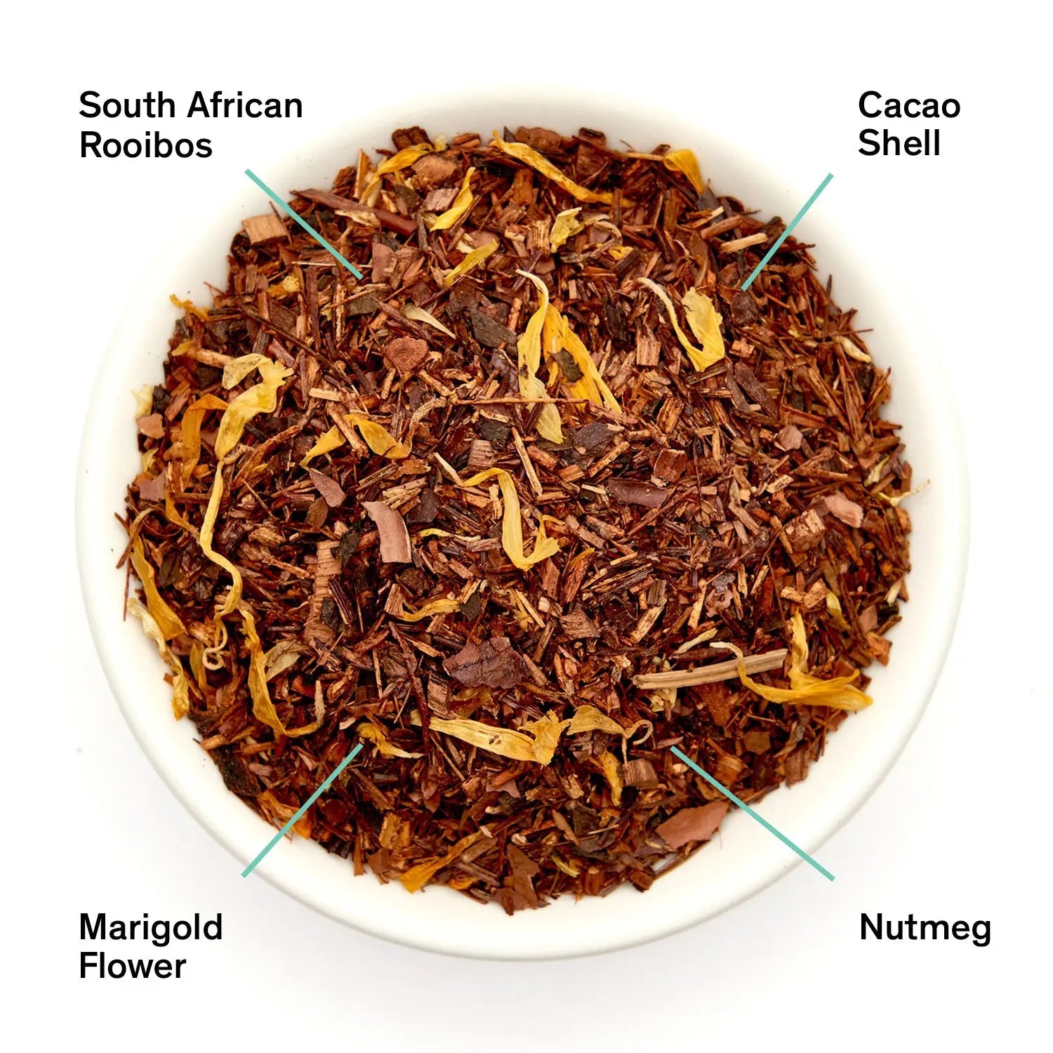 A bowl of Silent Night loose leaf tea featuring rooibos, cacao shell, marigold flowers, and nutmeg next to a black August Uncommon Tea bag.