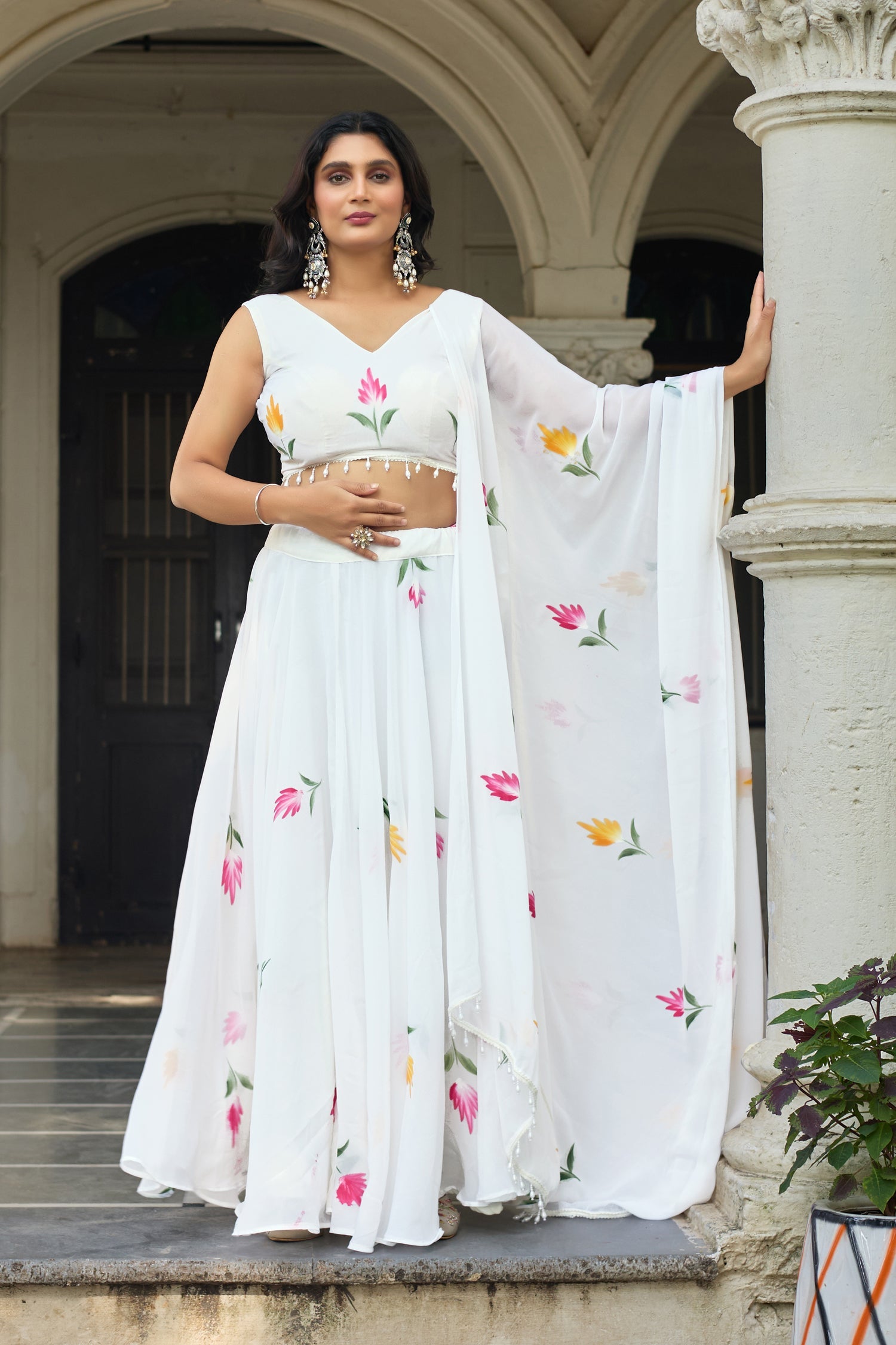 White georgette lehenga choli with hand-painted floral motifs and matching dupatta