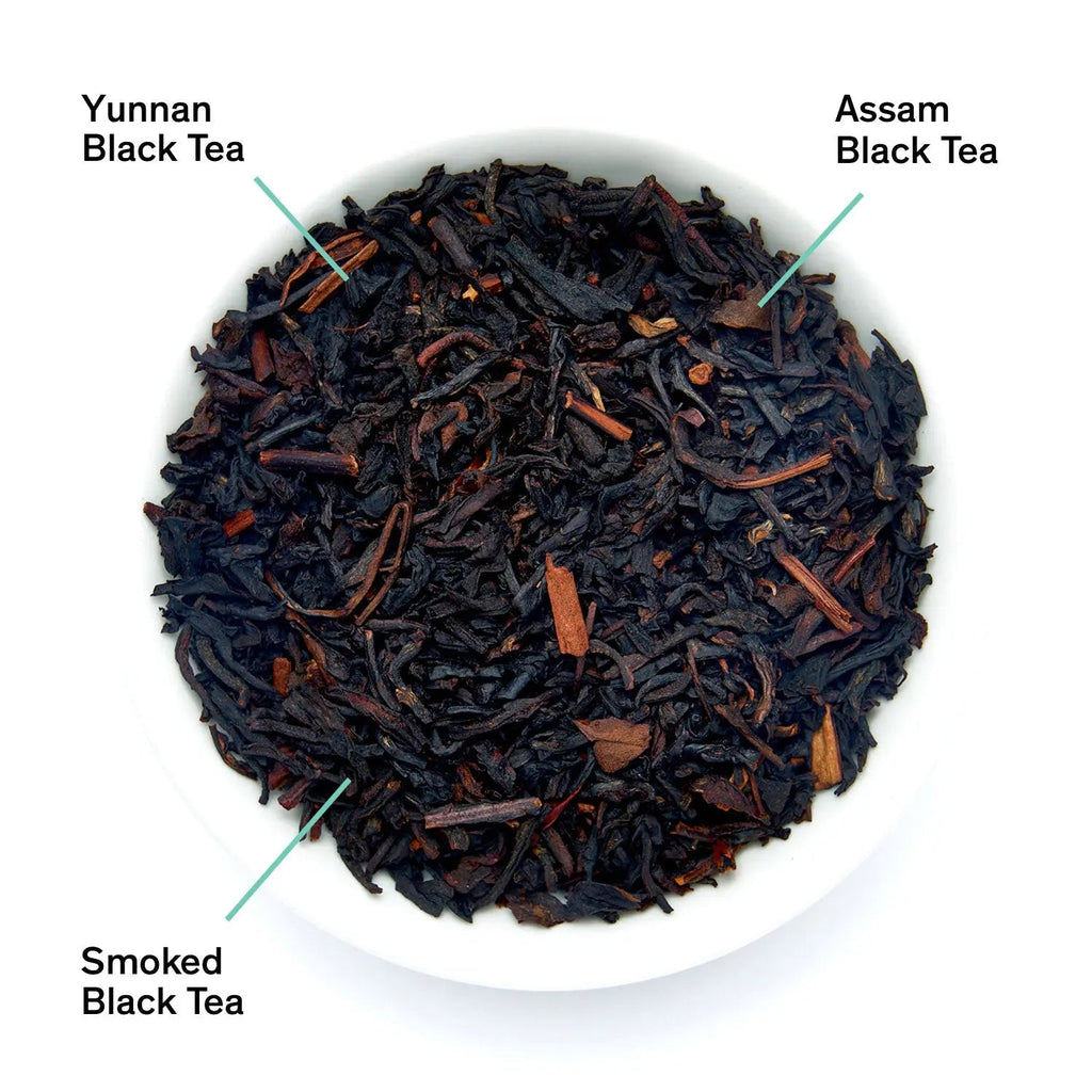 A pouch of Golden Arrow smoky toffee black tea next to a bowl of loose leaf tea blends.