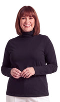 A woman wearing a long sleeve relaxed fit ribbed turtleneck top in solid black.