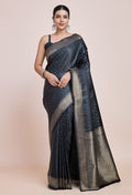 Dark teal Banarasi satin silk saree with ornate zari woven patterns