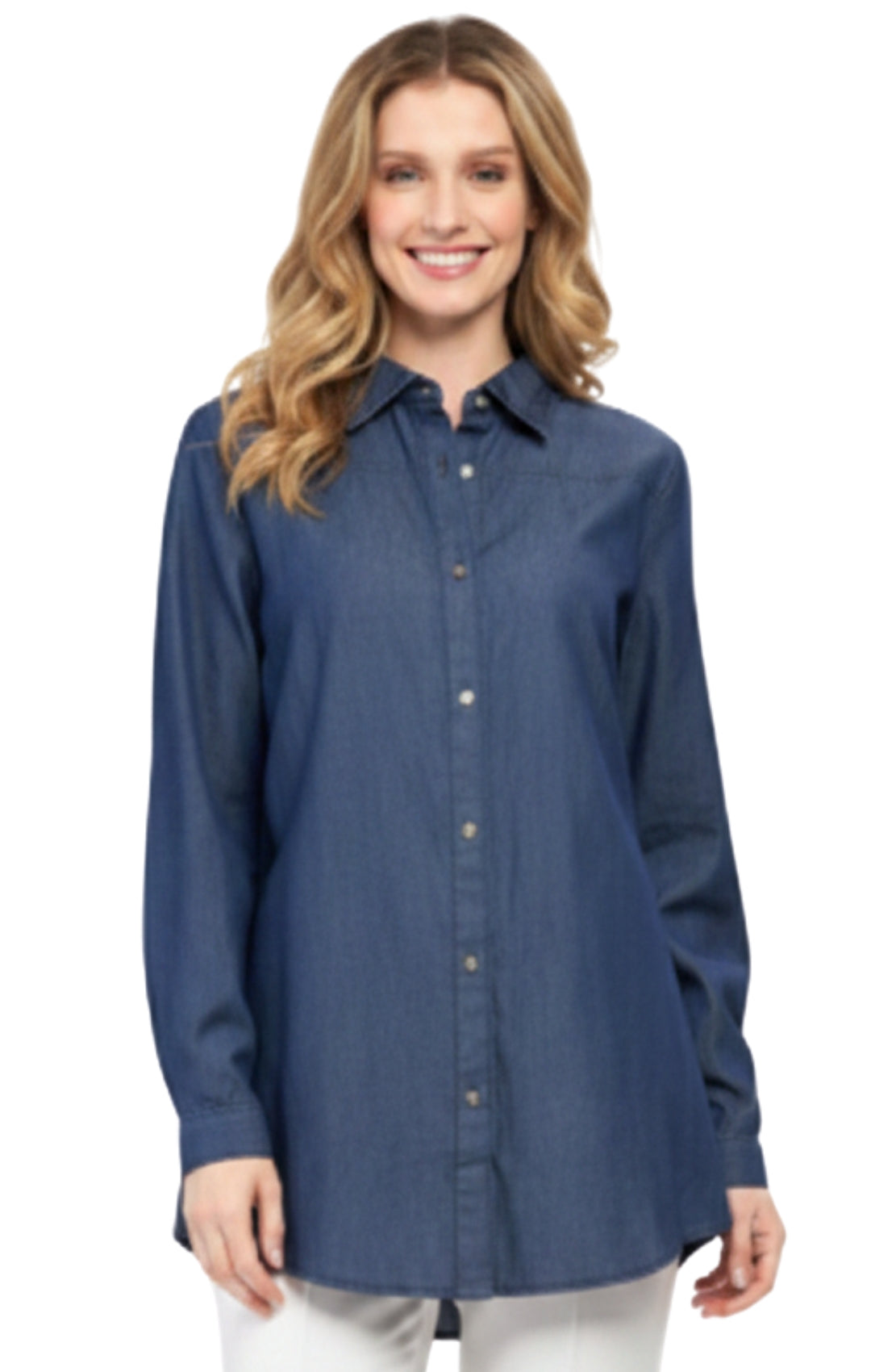 A woman wearing a classic long sleeve button-down denim tunic in medium blue indigo.