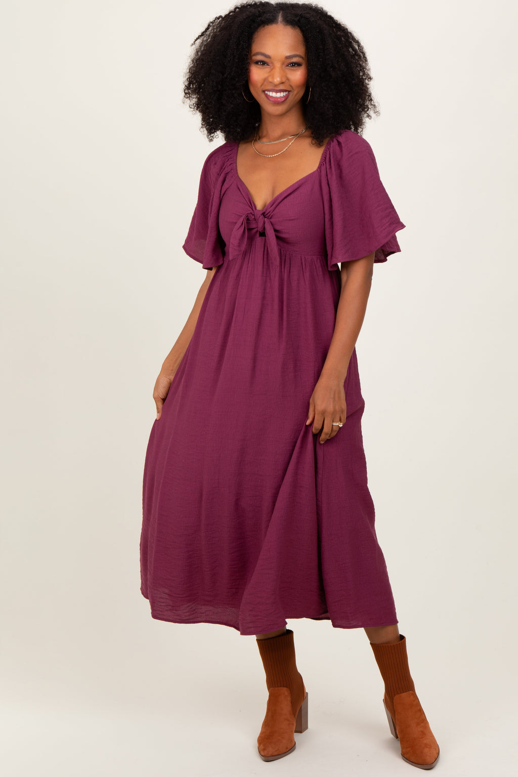 Elegant plum midi dress with feminine ruffle sleeves and a front tie waist.