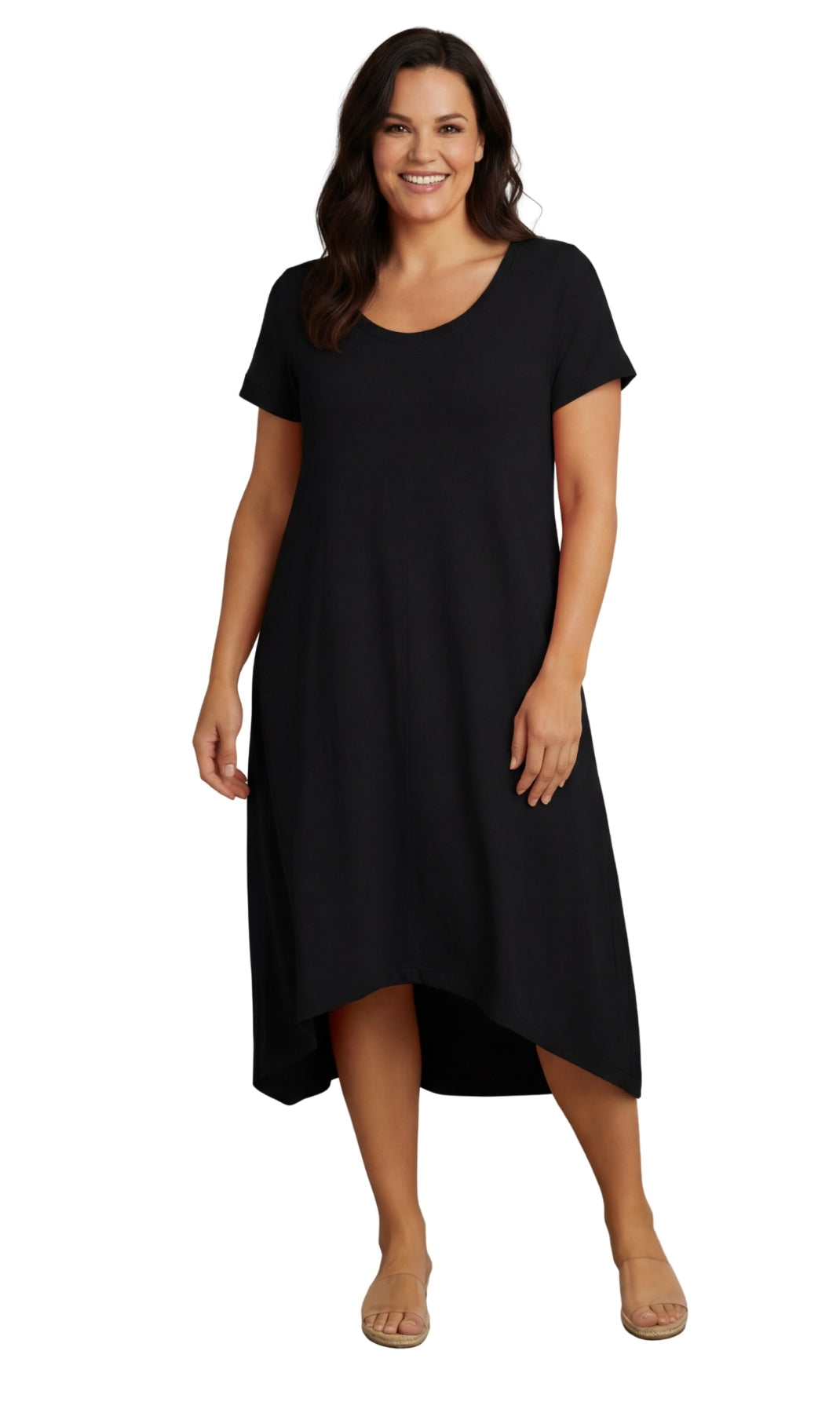 A woman wearing a rust-colored midi-length A-line knit dress with a scoop neck and an asymmetrical hem.