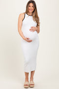 Pregnant woman wearing a white ribbed knit midi dress with black contrast trim