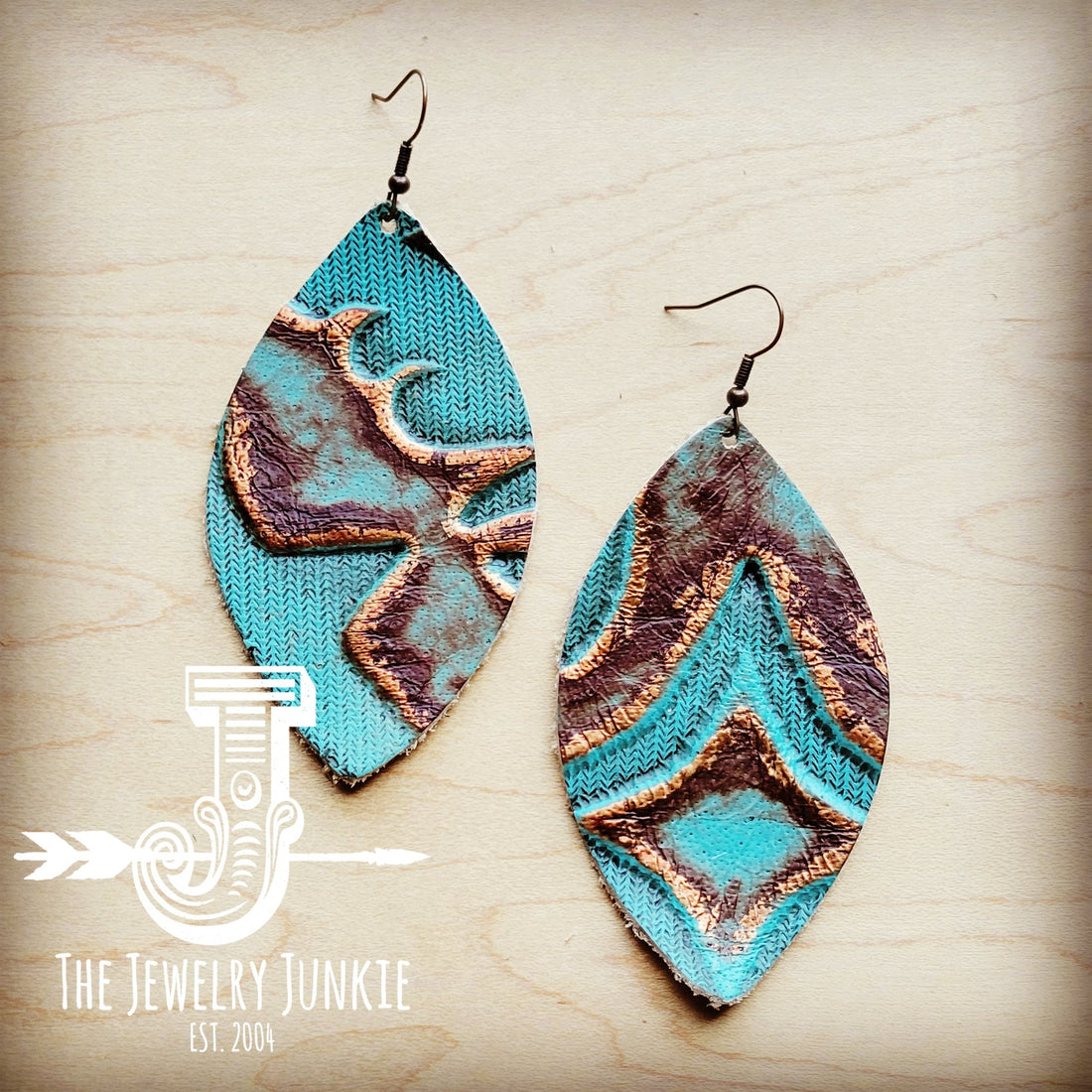 Copper Laredo oval leather earrings with a textured turquoise and copper western pattern