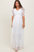 White lace maternity maxi dress with a stretchy smocked bodice and flowing skirt