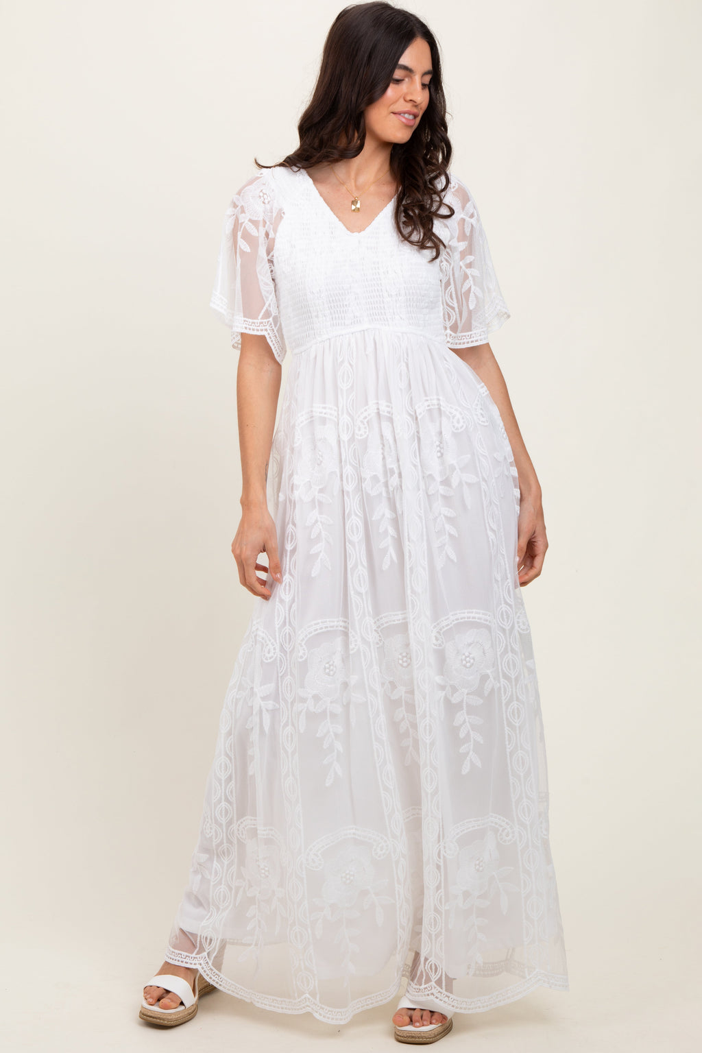 White lace maxi dress featuring a smocked bodice and flutter sleeves