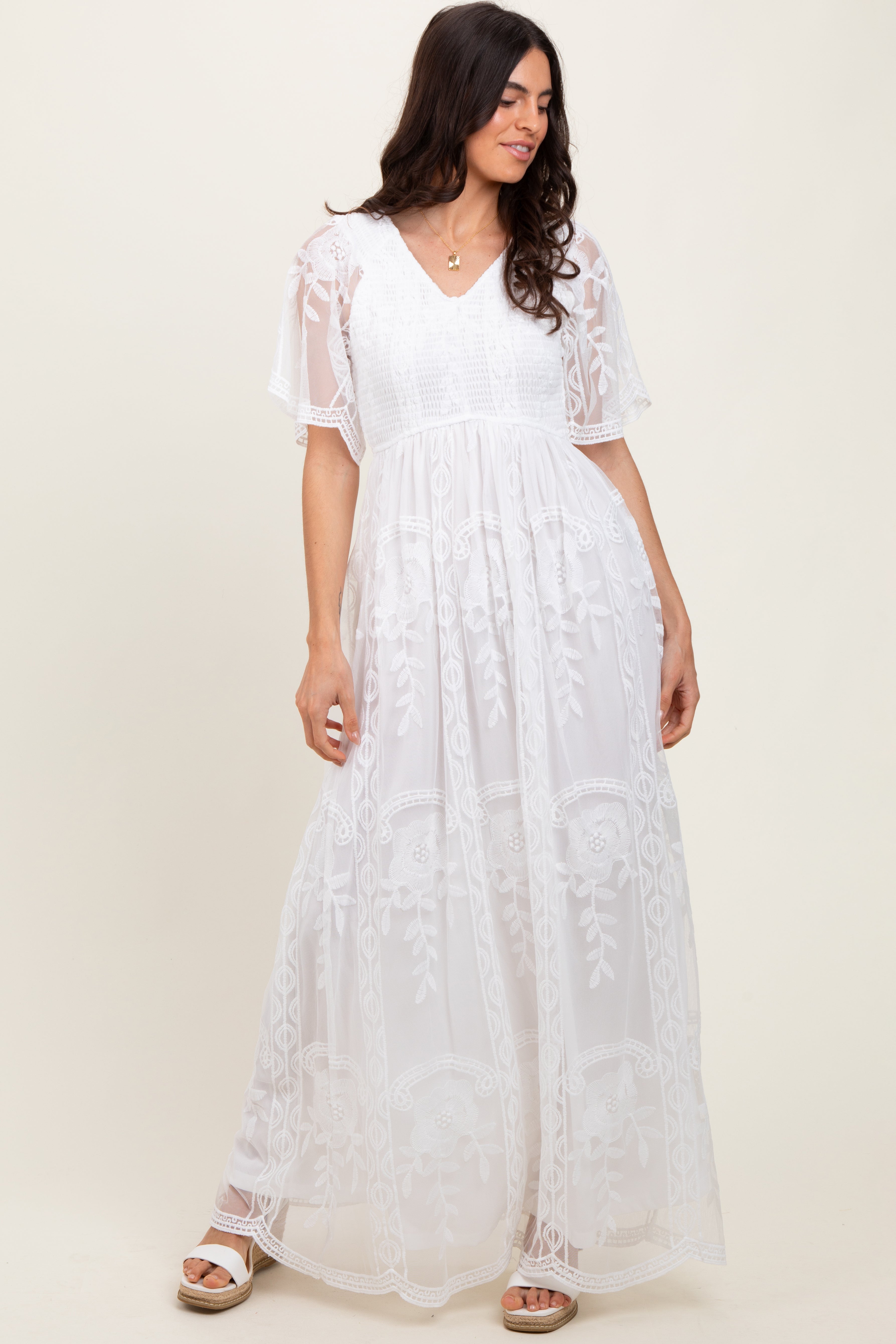 White lace maxi dress featuring a smocked bodice and flutter sleeves