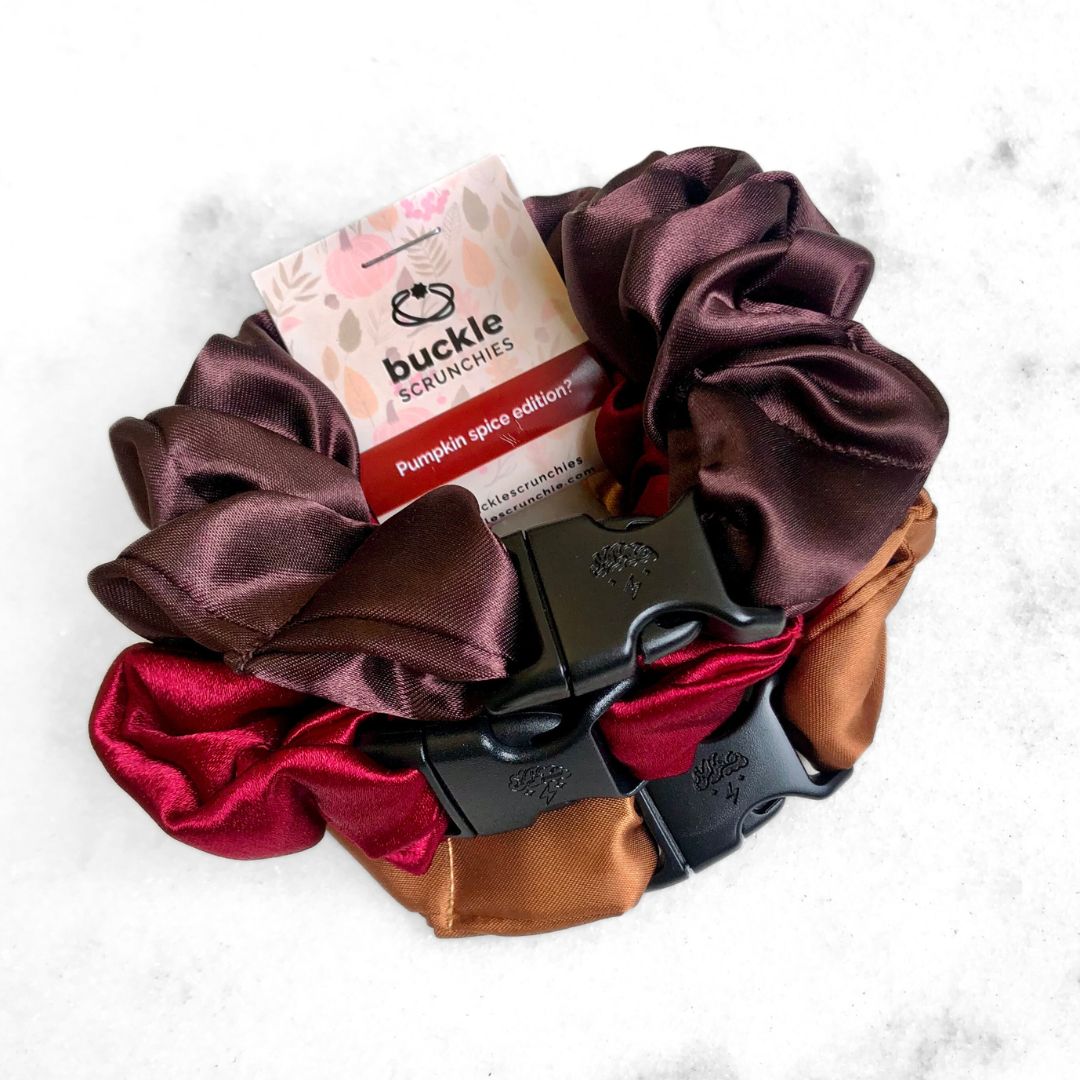 3-pack of autumn-colored satin hair scrunchies in Gingerbread Rust, Cherry Red, and Chocolate.