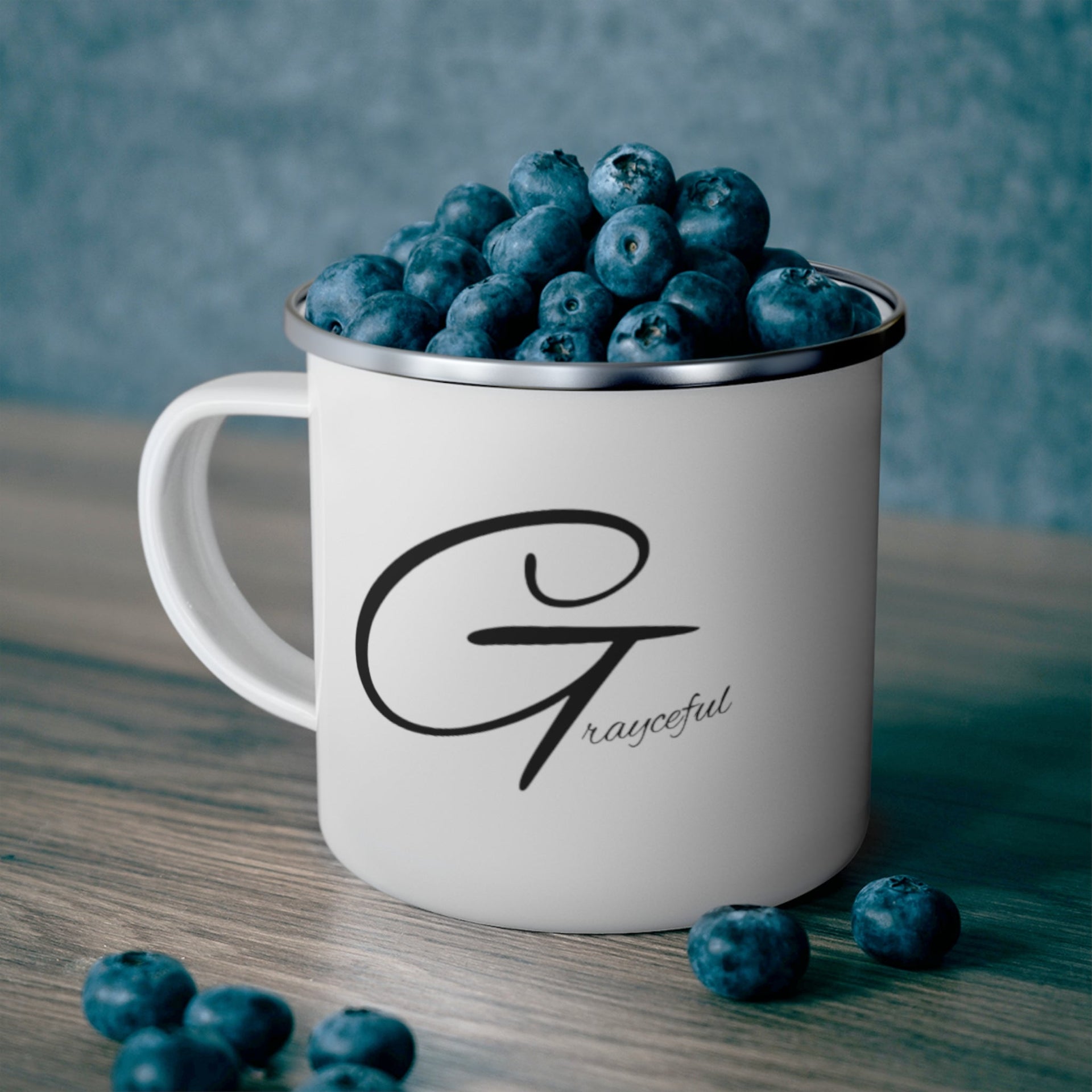 A sleek 12oz minimalist enamel camping mug available in white, silver, or black.