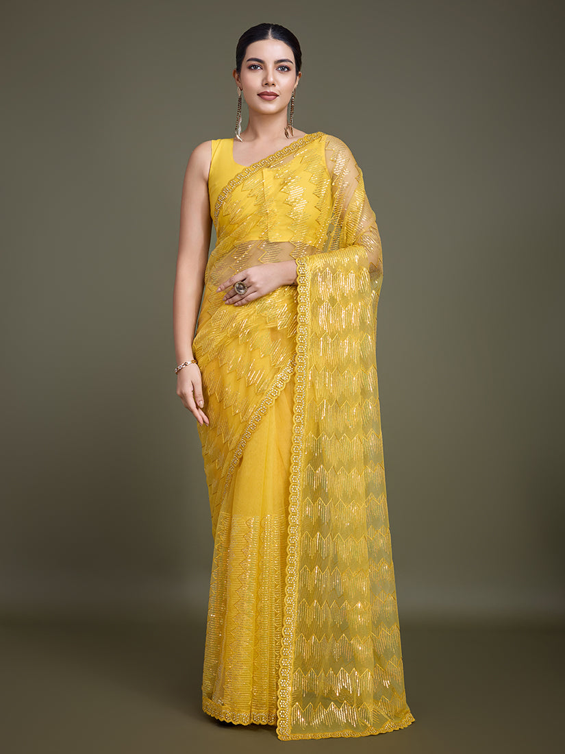 Yellow net saree adorned with sparkling sequins for party wear