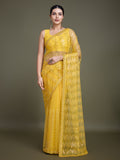 Yellow net saree adorned with sparkling sequins for party wear