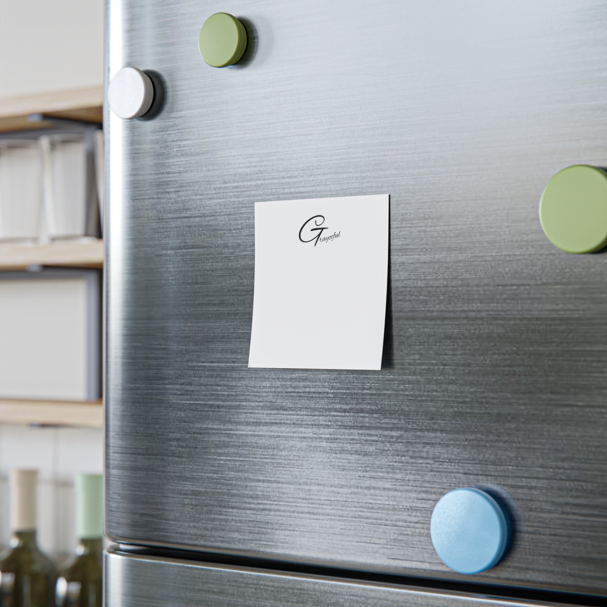 Minimalist square note pads with black typography on white paper, displayed in a modern office workspace.