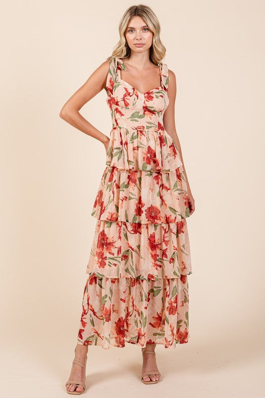 Woman wearing a romantic floral maxi dress with a sweetheart neckline and layered skirt